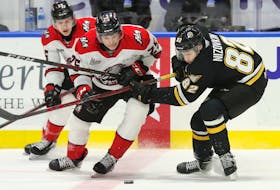 Donovan Arsenault, 25, of Richmond, P.E.I., battles for the puck in a Quebec Major Junior Hockey League game for the Rouyn-Noranda Huskies. The Huskies recently traded Arsenault to the Gatineau Olympiques. Mike Sullivan Photo/Courtesy of QMJHL