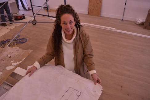 Toshia Noye examines some floor plans recently at her store, Tosh Co. Home Store, located at 53 Thompson Dr. in Charlottetown. The new store is expected to open in early 2022.