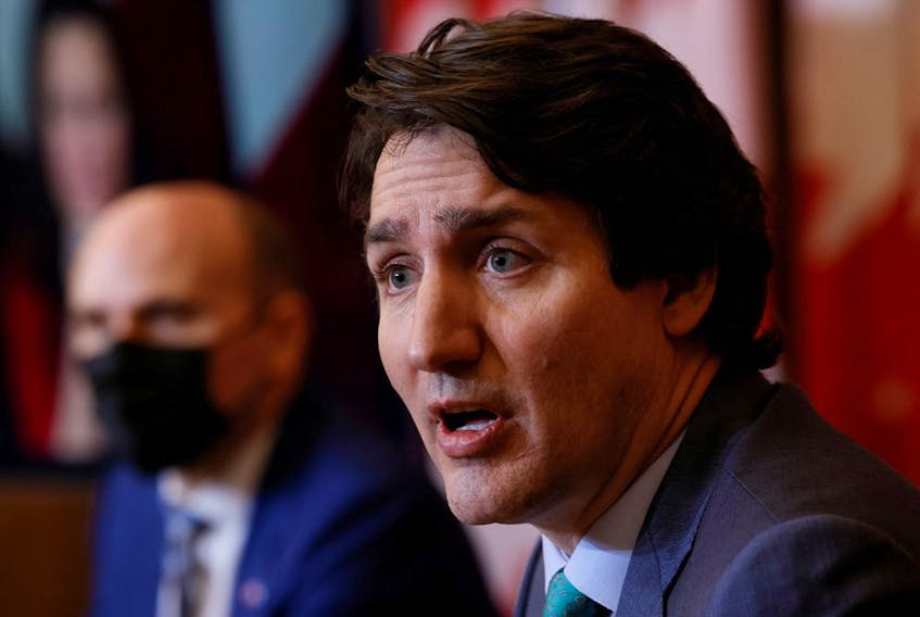 Prime Minister Justin Trudeau, with Minister of Health Jean-Yves Duclos, takes part in a news conference as the latest Omicron variant emerges as a threat amid the COVID-19 pandemic.