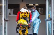  A patient is taken into a hospital by a paramedic in Montreal on Dec. 29, 2021.