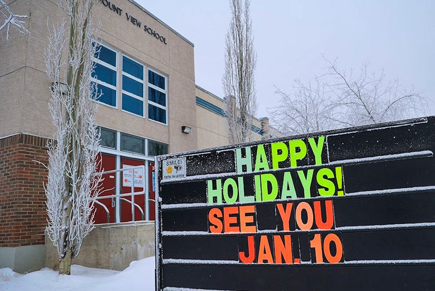 A sign outside Mount View School announces the postponement of return to classes on Monday, Jan. 3, 2022. Alberta has delayed the start date to help schools deal with COVID-19 precautions due the Omicron surge.