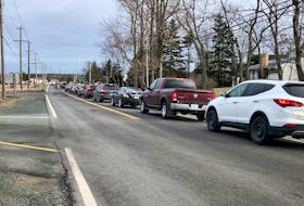 The line-up of vehicles of people looking to get take home COVID-19 rapid test kits in Coxheath was about 1.4 kilometers long for at least the first hour of distribution on Jan. 5. NICOLE SULLIVAN/CAPE BRETON POST 