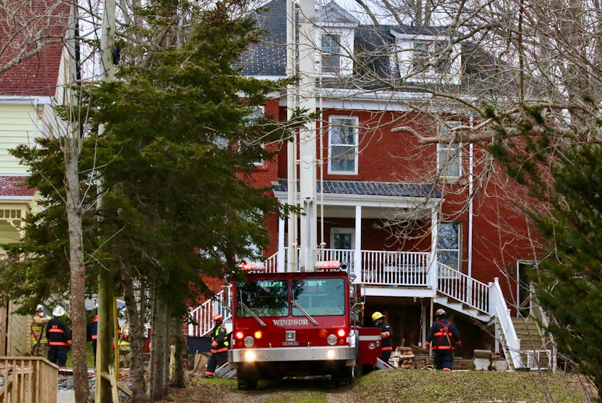 Windsor and Brooklyn firefighters called in both aerial devices they had at their disposal in order to check out the top of the chimney at this King Street residence Jan. 4.  Homeowners are asked to frequently check fireplaces for creosote build-up to prevent future chimney fires.