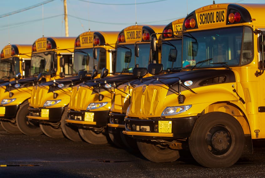 School buses sit parked in Harrietsfield on Thursday, Jan. 6, 2022.