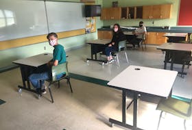 In this file photo from September 2020 taken at Munro Academy, students sit at desks separated six feet apart — a COVID-19 health protection measure not all schools are able to achieve. Pictured here are, from left, Liam Tingley, Katie Murphy and Sam Tingley. CONTRIBUTED/MUNRO ACADEMY 