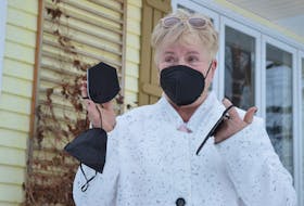 Pat Robinson shows some of her own N95 masks. She has ordered 100 more, which she will hand out around town to front-line service workers.