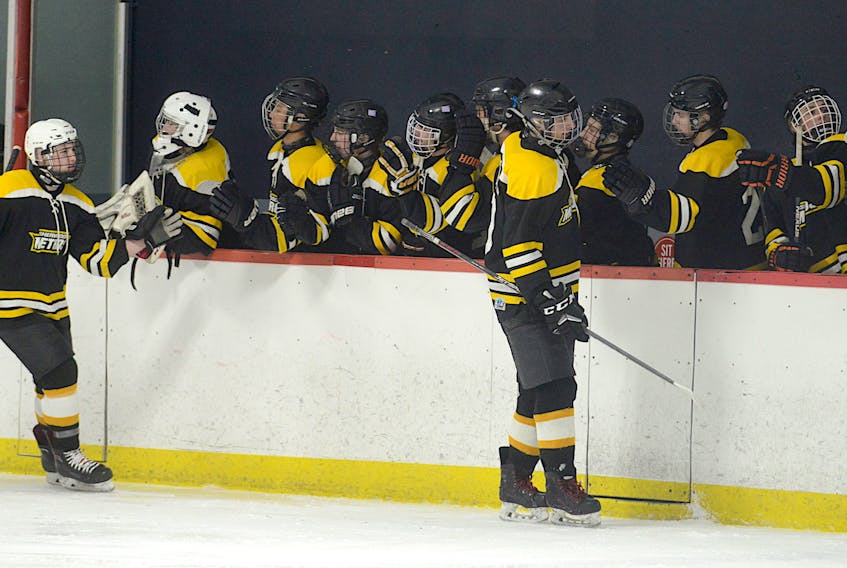 Sherwood Metros players on the bench celebrate a goal by their teammate in March 2021. 
