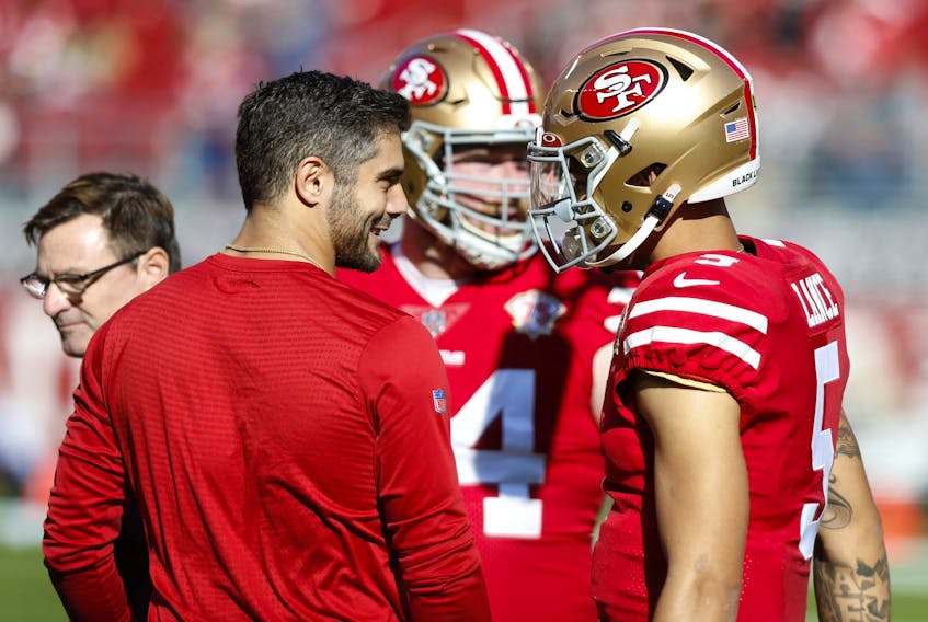 Jimmy Garoppolo (left) of the San Francisco 49ers talks with Trey Lance.