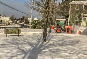 A snowplow clears a walkway in Sydney on Saturday morning following Friday evening's snowstorm. JESSICA SMITH/CAPE BRETON POST