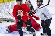  Senators centre Josh Norris, left, and defenceman Victor Mete battle for position in front of goaltender Filip Gustavsson during a practice this past week.
