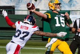 October 1, 2022  quarterback Taylor Cornelius (15) gets the ball away as he is hit by Wesley Sutton (37) as the Edmonton Elks and the Montreal Alouttes play at Commonwealth stadium in Edmonton.
BRUCE EDWARDS/Edmonton Journal