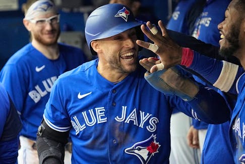 Blue Jays centre fielder George Springer (centre)  celebrates scoring against the Red Sox during the fifth inning at Rogers Centre in Toronto, Saturday, Oct. 1, 2022.