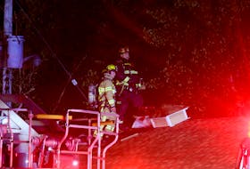 Firefighters made ventilation access holes throughout the roof of the Downeast Motel in an effort to quickly knockdown a fire at the Garlands Crossing facility Sept. 30.