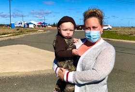 Georgia White holds her son Easton Lewis near the mobile primary healthcare clinic that Nova Scotia Health has opened in Membertou, off Highway 125, on September 30. NICOLE SULLIVAN / CAPE BRETON POST