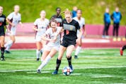 Capers' Emma Clark, No. 9, holds off a Mount Allison Mounties player during AUS women's soccer play on Saturday in Sackville, N.B. CONTRIBUTED