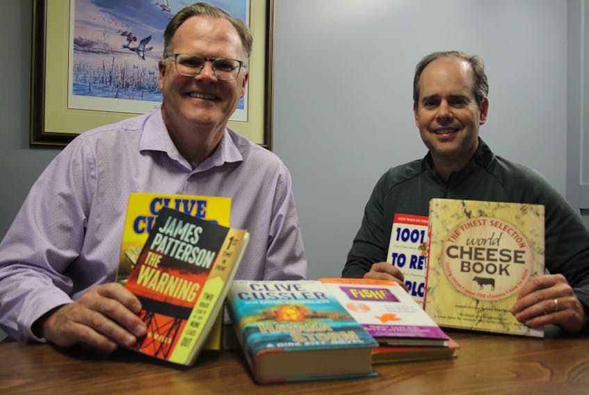 Sandy Rundle, left, and Chad Mann, rotarians for the Rotary Club of Summerside, are getting ready for the annual Rotary Book Drive. The book sale funds local literacy programs in the city, including the library and, recently, Summerside Intermediate School. – Kristin Gardiner