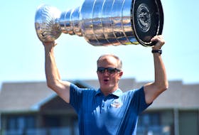 In this file photo, Al MacInnis lifts the Stanley Cup over his head during the Chestico Days parade in Port Hood in August 2019. MacInnis, a Port Hood product, will be among the inaugural inductees into the newly established St. Louis Blues Hall of Fame this week. JEREMY FRASER/CAPE BRETON POST.