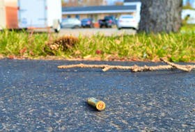 A bullet found by the Cape Breton Post on the driveway of the home next to the Highland Motel in North Sydney on Thursday, exactly one week after Cape Breton Regional Police arrested a man after receiving reports of gunshots. In the background is the Highland Motel. NICOLE SULLIVAN/CAPE BRETON POST