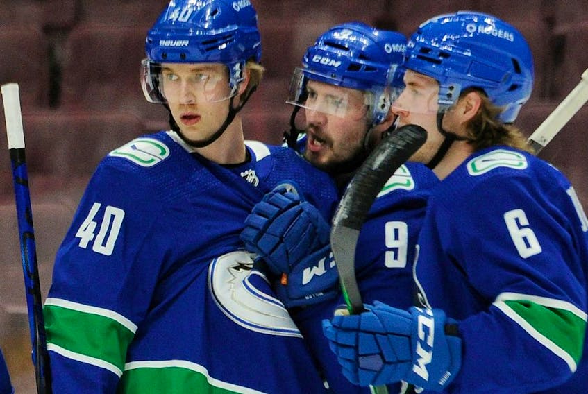  From left, Canucks’ Elias Pettersson, J.T. Miller and Brock Boeser celebrate Bo Horvat’s goal against the Montreal Canadiens in NHL action at Rogers Arena in Vancouver on Jan. 20, 2021.