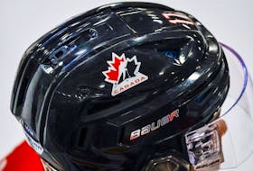 A Hockey Canada logo is visible on the helmet of a national junior team player.