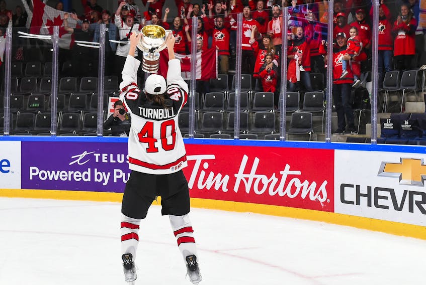 Blayre Turnbull of Stellarton, N.S. celebrates with the championship trophy after Canada’s 2-1 win over the United States in the final of the IIHF world women’s hockey championship, September 2022. — International Ice Hockey Federation photo