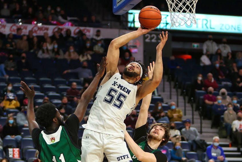 St. Francis Xavier X-Men forward David Muenkat pulls down a rebound and scores against the UPEI Panthers during the 2022 Atlantic university basketball championship semifinal at Scotiabank Centre. - NICK PEARCE