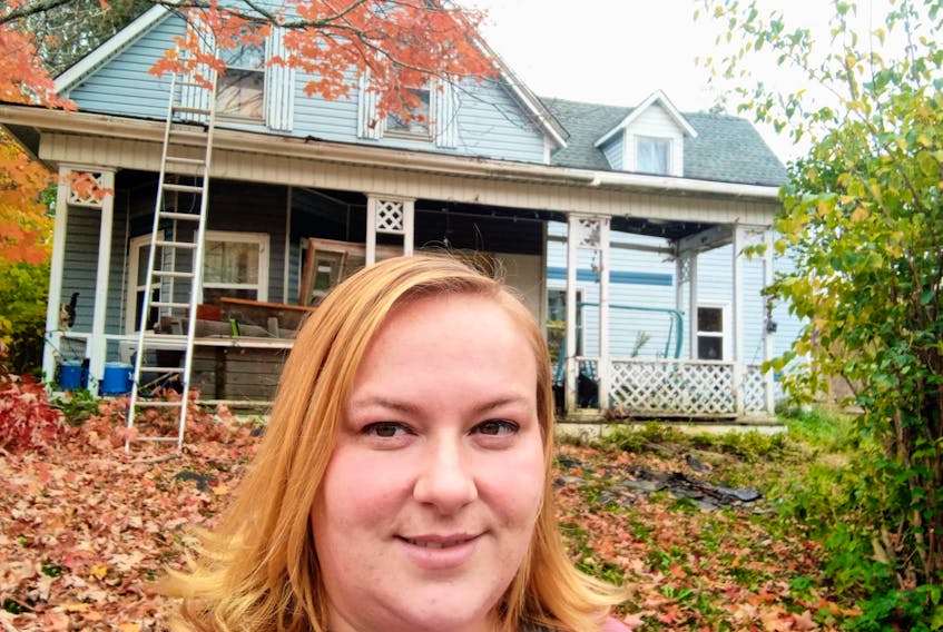 Nicole Fraser stands in front of her four-bedroom rural home that she believes is haunted. The home was a former hospital in Thorburn, N.S. - Contributed