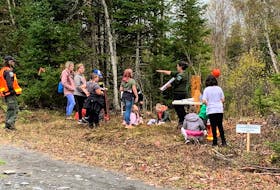 Forester Lizz Cogan speaking to a group of students led around the Leggate woodlands by forest technician Tom Prest.