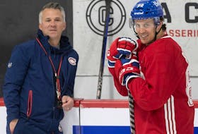 Montreal Canadiens head coach Martin St-Louis talks with Gabriel Bourque during the first day of training camp in Brossard on Sept. 22, 2022.