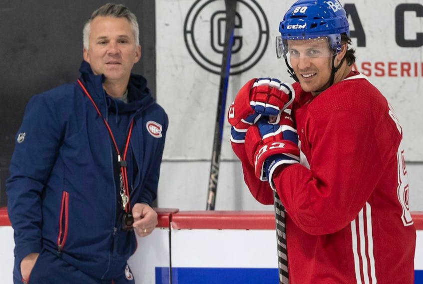 Montreal Canadiens head coach Martin St-Louis talks with Gabriel Bourque during the first day of training camp in Brossard on Sept. 22, 2022.