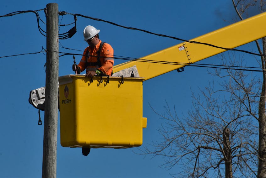 A Maritime Electric worker stays steady as he works on the Kingston Road Sept. 30.