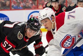  Ottawa Senators centre Shane Pinto (57) faces off against Montreal Canadiens centre Jake Evans (71) in the first period at the Canadian Tire Centre.