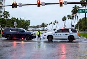 Sarasota County Sheriff Deputies block the access to a downtown bridge over to the barrier islands as hurricane Ian approached Florida’s Gulf Coast in Sarasota, Florida on Wednesday. Big Pond resident Helen Doherty, who owns a property on Anna Maria Island that forms part of the barrier islands, says she's had to deal with the effects of both post-tropical storm Fiona and hurricane Ian in the same week, causing a wide range of emotions. REUTERS/Steve Nesius