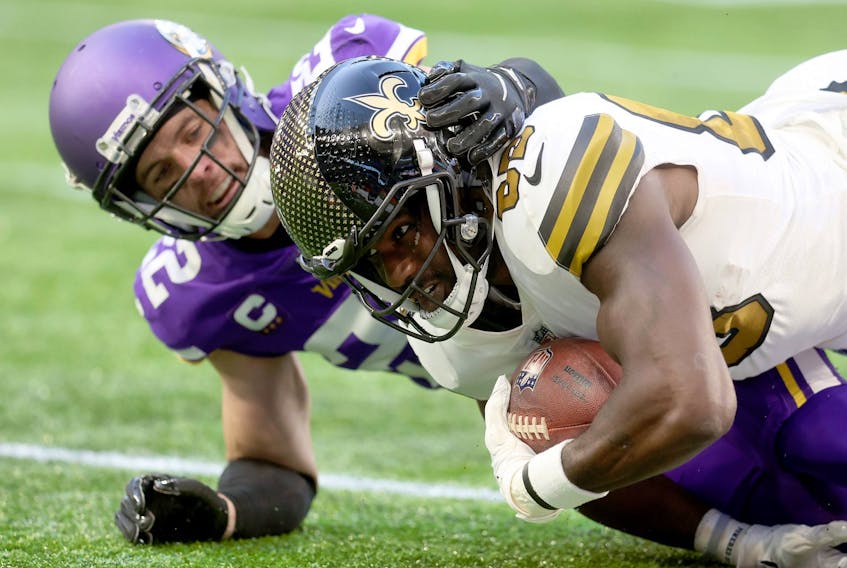 Juwan Johnson #83 of the New Orleans Saints is challenged by Harrison Smith #22 of the Minnesota Vikings during the NFL match between Minnesota Vikings and New Orleans Saints at Tottenham Hotspur Stadium on October 02, 2022 in London, England.  