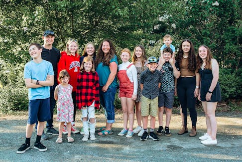 Cara Carruthers-Fury, with 13 of her nieces and nephews, in the middle, wearing blue, says they have been a major inspiration for her to volunteer with multiple Tatamagouche organizations. She is the County of Colchester’s nominee for the 2022 provincial volunteer of the year. KATIE DEVINE PHOTOGRAPHY