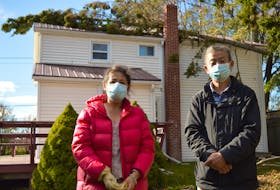 Hong Li, left, and her husband, Jingyuang Dong, say the tree that fell on their house on Mount Edward Road in Charlottetown during post-tropical storm Fiona knocked their mast off and left them without power for almost a month. Dave Stewart • The Guardian
