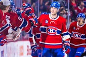 Canadiens' Juraj Slafkovsky gets high fives from team-mates after scoring his first career goal against the Arizona Coyotes during second period of National Hockey League game in Montreal Thursday Oct. 20, 2022.