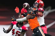  The B.C. Lions’ Lucky Whitehead fails to make the reception as the Calgary Stampeders’ Javien Elliott, back right, and Trumaine Washington defend at BC Place in Vancouver on Sept. 24, 2022.