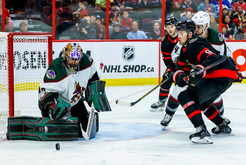 Senators centre Josh Norris and Coyotes goaltender Karel Vejmelka track a rebound during the third period of Saturday’s game. Norris later suffered what appeared to be a shoulder injury.