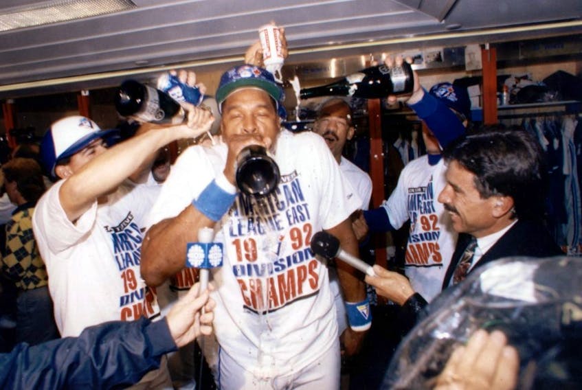  Dave Winfield guzzles some champagne in the middle of a chaotic Jays clubhouse after Toronto won the World Series. But this would be the only year Winfield played in a Jays uniform. STAN BEHAL/SUN FILES