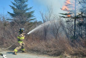 A firefighter is seen battling a blaze in Newfoundland and Labrador in this 2014 file photo. Trees and branches that fell during post-tropical storm Fiona could provide fuel for forest fires next year, according to the Nova Scotia Department of Natural Resources and Renewables. Keith Gosse/The Telegram