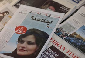 FILE PHOTO: A newspaper with a cover picture of Mahsa Amini, a woman who died after being arrested by Iranian morality police is seen in Tehran, Iran, September 18, 2022. Majid Asgaripour/WANA (West Asia News Agency) via REUTERS//File Photo  A newspaper with a cover picture of Mahsa Amini, a woman who died after being arrested by Iranian morality police, is seen in Tehran, Iran on Sept. 18, 2022. Amini’s death has sparked protests by mostly young Iranians against its government regime. Majid Asgaripour/WANA (West Asia News Agency) via REUTERS//File Photo