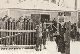 A skating party eagerly waits outside the dressing room building to enter the ice at Hamilton's Rink off Walker Street in Truro.