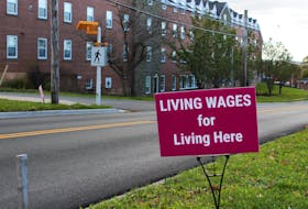 A strike sign at the Dalhousie Agricultural Campus in Bible Hill reads, "living wages for living here."