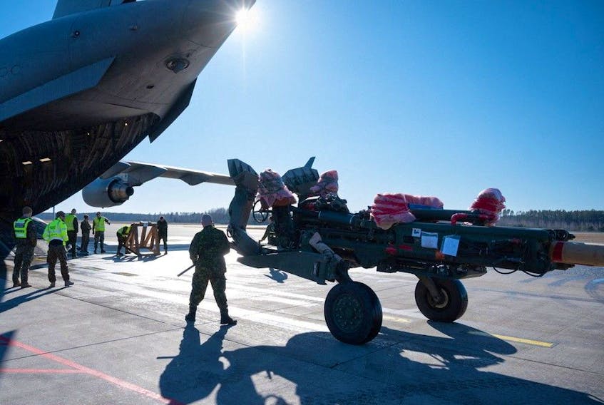 File photo: A battery of Canadian M777 howitzers, TAPV armoured vehicles and related equipment is unloaded at the airport in Riga, Latvia.