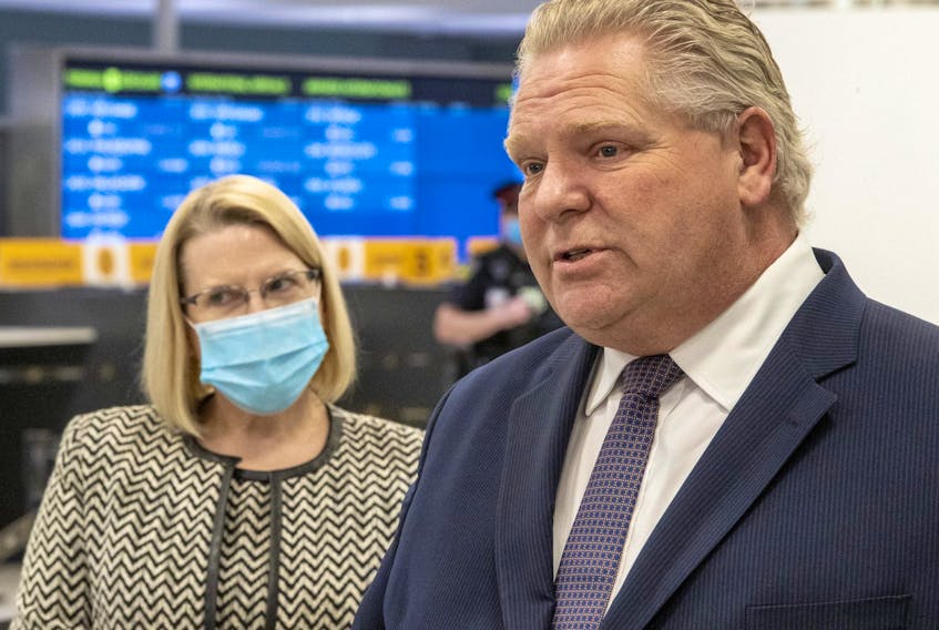 Ontario Premier Doug Ford and Solicitor General Sylvia Jones answer questions after touring the COVID-19 testing centre in Terminal 3 at Pearson Airport in Toronto on February 3, 2021.   