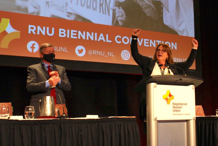 Registered Nurses' Union president Yvette Coffey gives a speech at the 28 RNU Biennial Convention. From left: RNU executive director and chief negotiator John Vivian and RNU president Yvette Coffey.