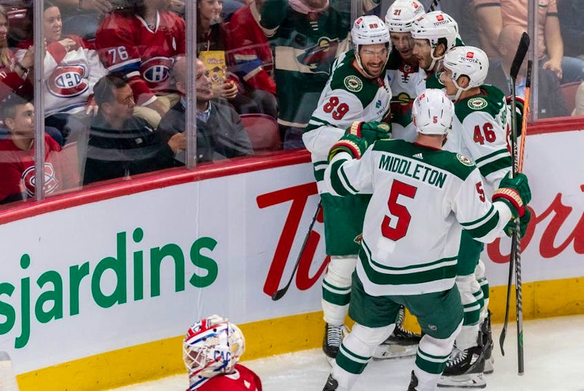 Minnesota Wild right wing Brandon Duhaime (21) is congratulated by teammates after scoring against Montreal Canadiens goaltender Jake Allen (34) during 2nd period NHL action at the Bell Centre in Montreal on Tuesday Oct. 25, 2022.