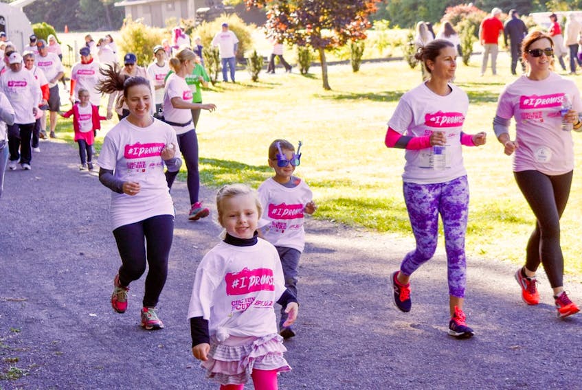 People take part in a Run for the Cure event in support of breast cancer awareness and funding. 