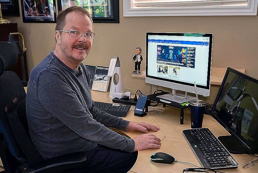  Photo of former NHLer Mark Kirton at his home in Oakville, Ontario where he still manages to manipulate a keyboard with one finger.